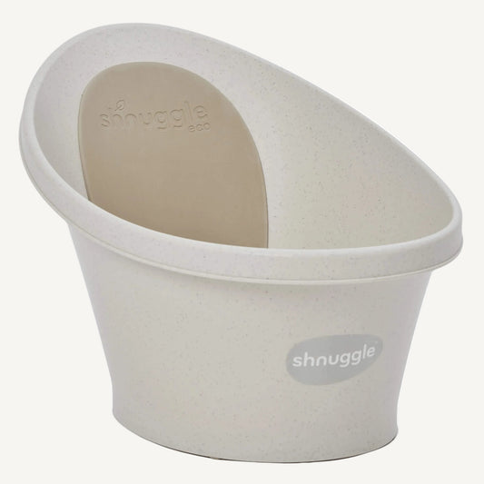 Cream-coloured baby bath tub shown angled to display its curved sides and ergonomic backrest.