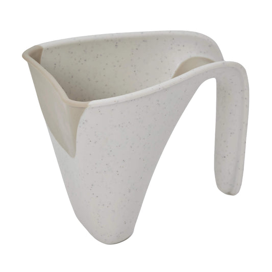 Angled view of a cream jug with curved lip and soft-touch edge designed for pouring water.