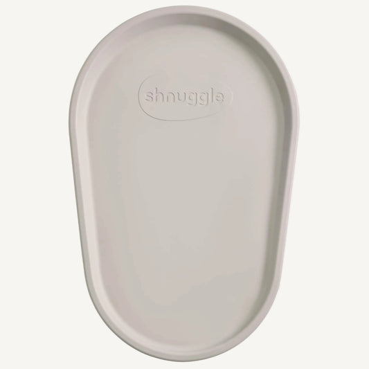 The Shnuggle Squishy Changing Mat in taupe, a soft and supportive baby changing surface with contoured edges and wipe-clean finish.