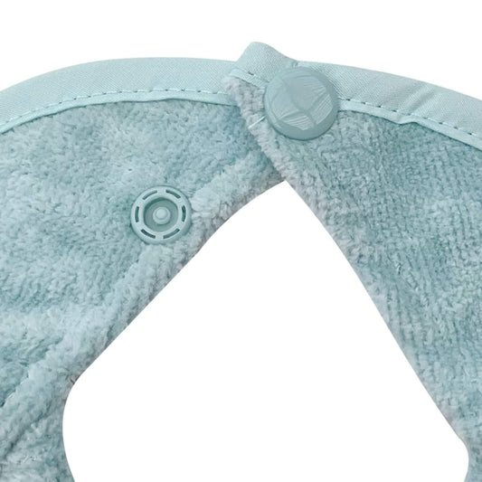 Close-up of Silly Billyz Biblet double snap closure – adjustable fit to grow with baby, shown in Maitai Bay blue towelling.