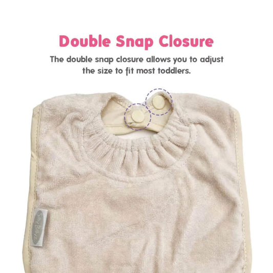 Close-up of a white sand baby bib showing the gathered snuggle neck design with double snap fastenings for adjustable sizing.