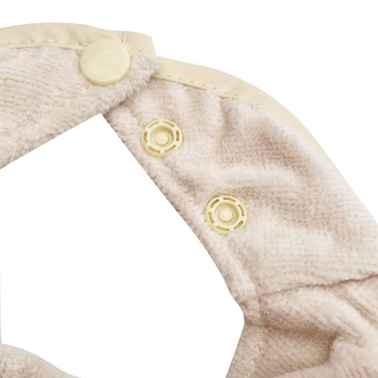 Close-up of Silly Billyz towel bandana bib in white sand, showing soft towelling fabric and secure pop-stud closure for adjustable fit.