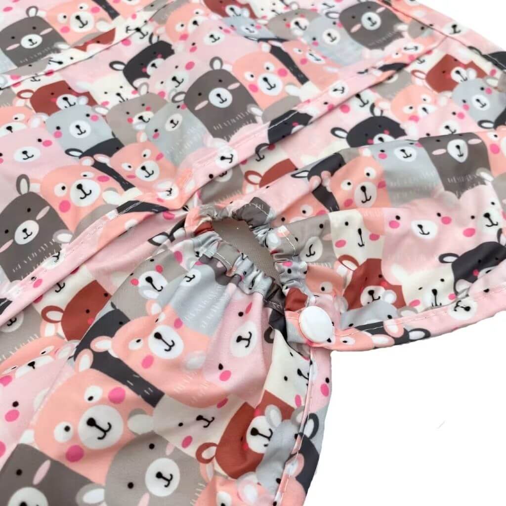 Elasticated hem and snap closure detail of Silly Billyz Peekaboo long sleeve highchair hugger bib, highlighting the secure, practical fit.