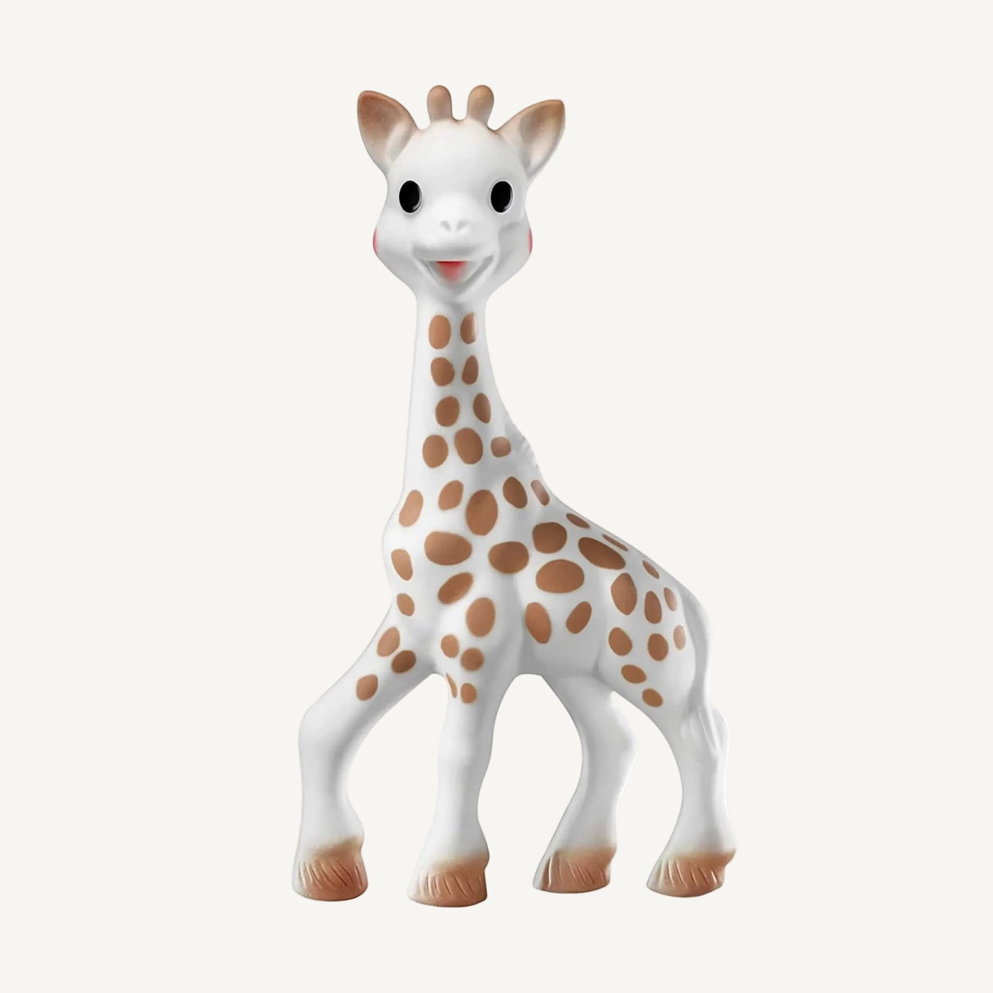 A white natural rubber giraffe-shaped baby teething toy standing upright, with brown spotted markings, rounded horns, and softly textured hooves.