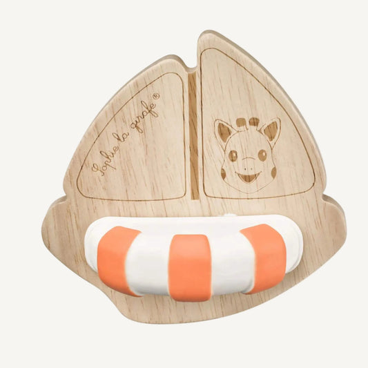 A wooden sailboat toy made from light natural rubberwood with engraved giraffe detail and a striped natural rubber float attached at the base.