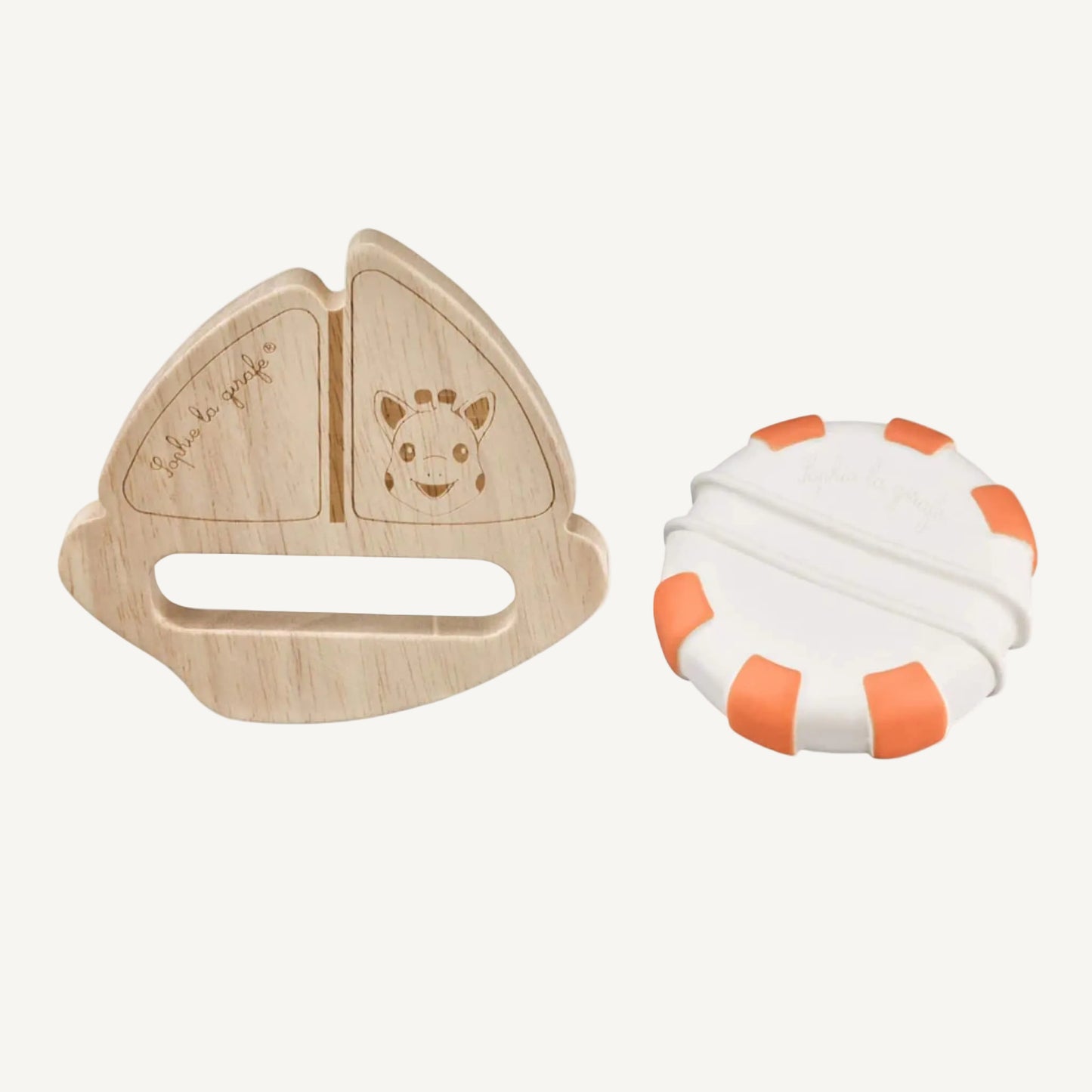 A wooden sailboat toy and a separate white and orange striped natural rubber float placed side by side on a plain background.