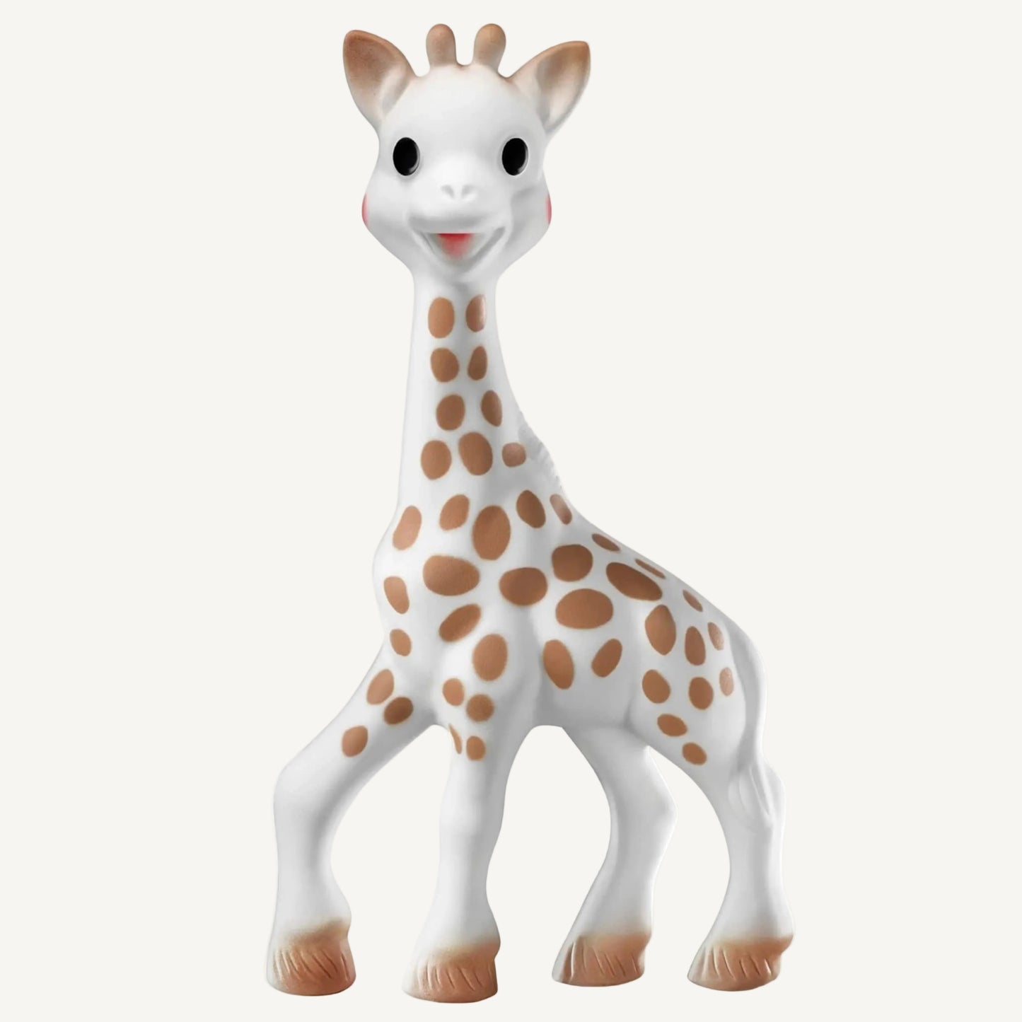 A natural rubber giraffe toy standing upright, featuring brown spots, smooth rounded legs, and a gentle facial expression.