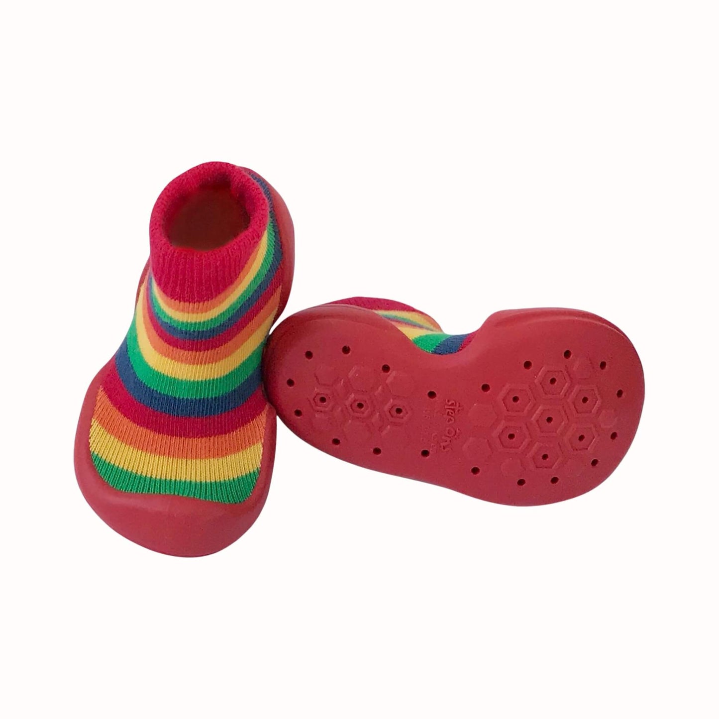 Rainbow striped Step Ons with red soles, soft knitted uppers and a textured non-slip grip pattern underneath.