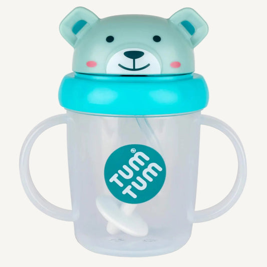 A clear sippy cup with two side handles, a weighted straw inside, and a blue bear-shaped lid fitted on top.