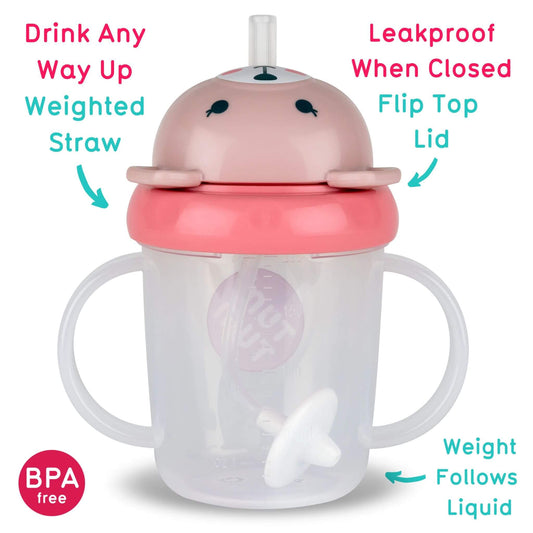 A Series 3 TUM TUM Tippy Up Cup featuring a pink bear design with a flip-top lid for easy access. The cup includes a weighted straw that follows the liquid, making it easy to drink from any angle. It’s BPA-free, leakproof when closed, and designed with easy-grip handles for toddlers.