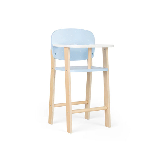 Side angle of the wooden doll’s highchair showing curved tray and smooth blue backrest with polka dots.