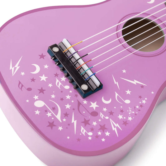 Close-up of the guitar body showing colourful nylon strings and a detailed pattern of stars, lightning bolts, and music notes.