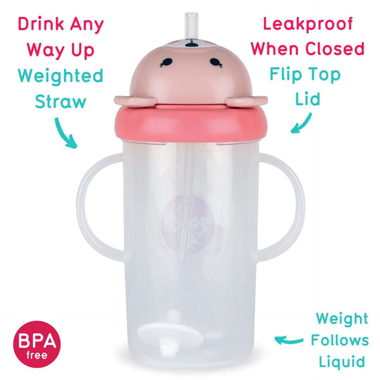 A toddler sippy cup with a pink bear-shaped lid, featuring a leakproof flip-top and weighted straw that allows for drinking from any angle. The BPA-free cup has easy-grip handles and a weighted base that follows the liquid.