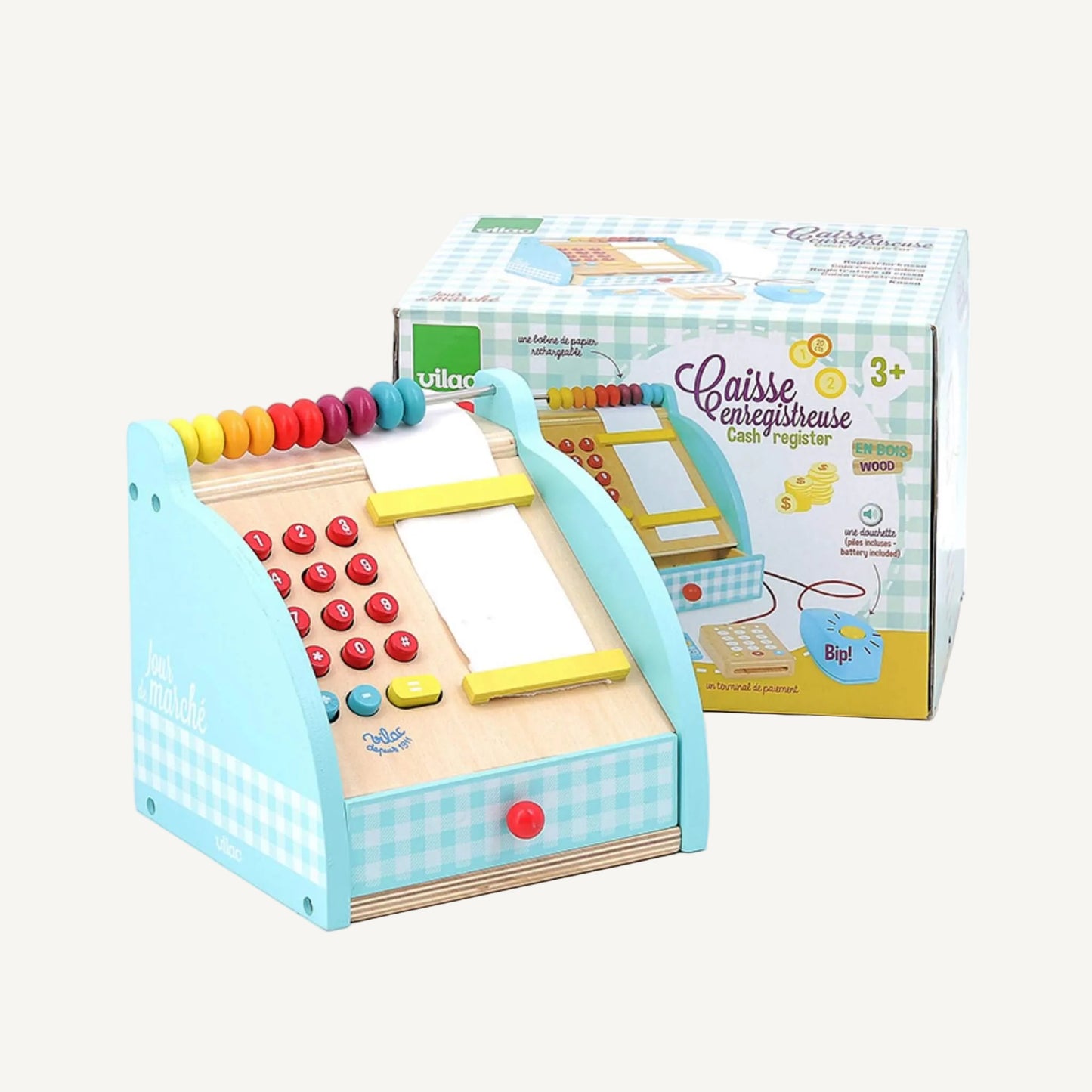 A wooden toy cash register placed in front of its box, showing keypad buttons, bead abacus, receipt roll, and closed drawer.