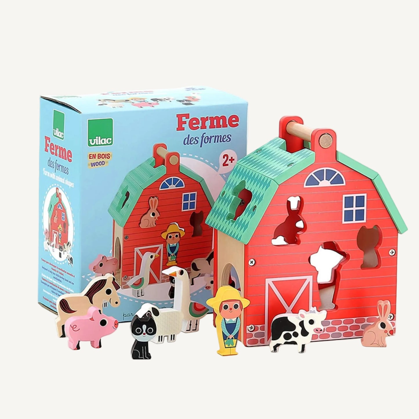 A boxed wooden farm shape sorter toy displayed with barn and animal figures arranged in front of packaging showing product illustration and branding.
