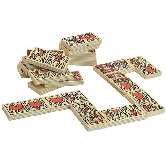 Wooden domino tiles with art illustrations of red hearts and figures, shown stacked and in play formation on a white surface.