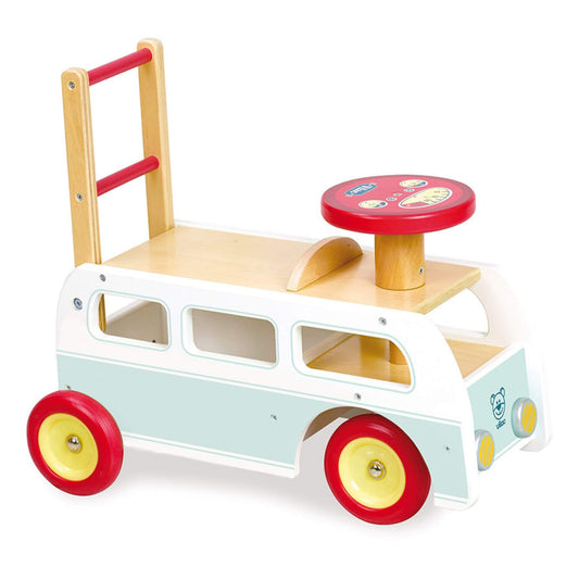 A wooden retro campervan-style walker with red wheels, a mint green body, and a red circular seat viewed from the front left side.