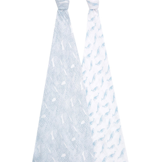 Aden + anais organic swaddles displayed hanging to show full whale and dotted ocean-inspired prints in calming blue hues.