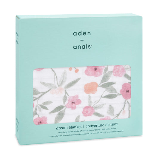 Boxed aden + anais cotton muslin Dream Blanket with a soft floral print in pink and green tones, displayed through a window in turquoise packaging.