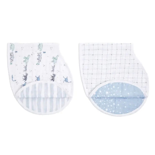 Folded aden + anais Burpy Bibs in Rising Star print, showing curved shape and contrasting inner muslin layers.