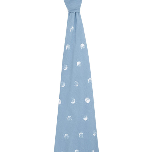 Unfolded aden + anais Blue Moon swaddle blanket tied at the top. Shows soft stretch and full moon print detail.