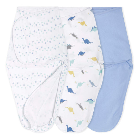 aden + anais swaddle wraps in dinosaur, footprint, and solid blue prints, opened flat to show inner shape.
