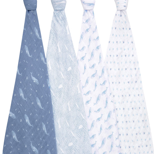 Four hanging aden + anais Oceanic swaddles showcasing soft blue marine prints. Gentle on baby’s skin and perfect for swaddling, cuddles, and more.
