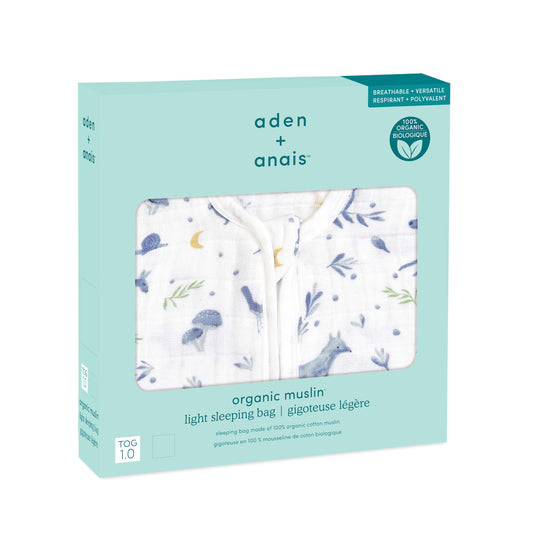 aden + anais organic muslin sleeping bag in boxed packaging. Features forest-themed print in soft blues. Breathable 1.0 TOG for warmer nights.