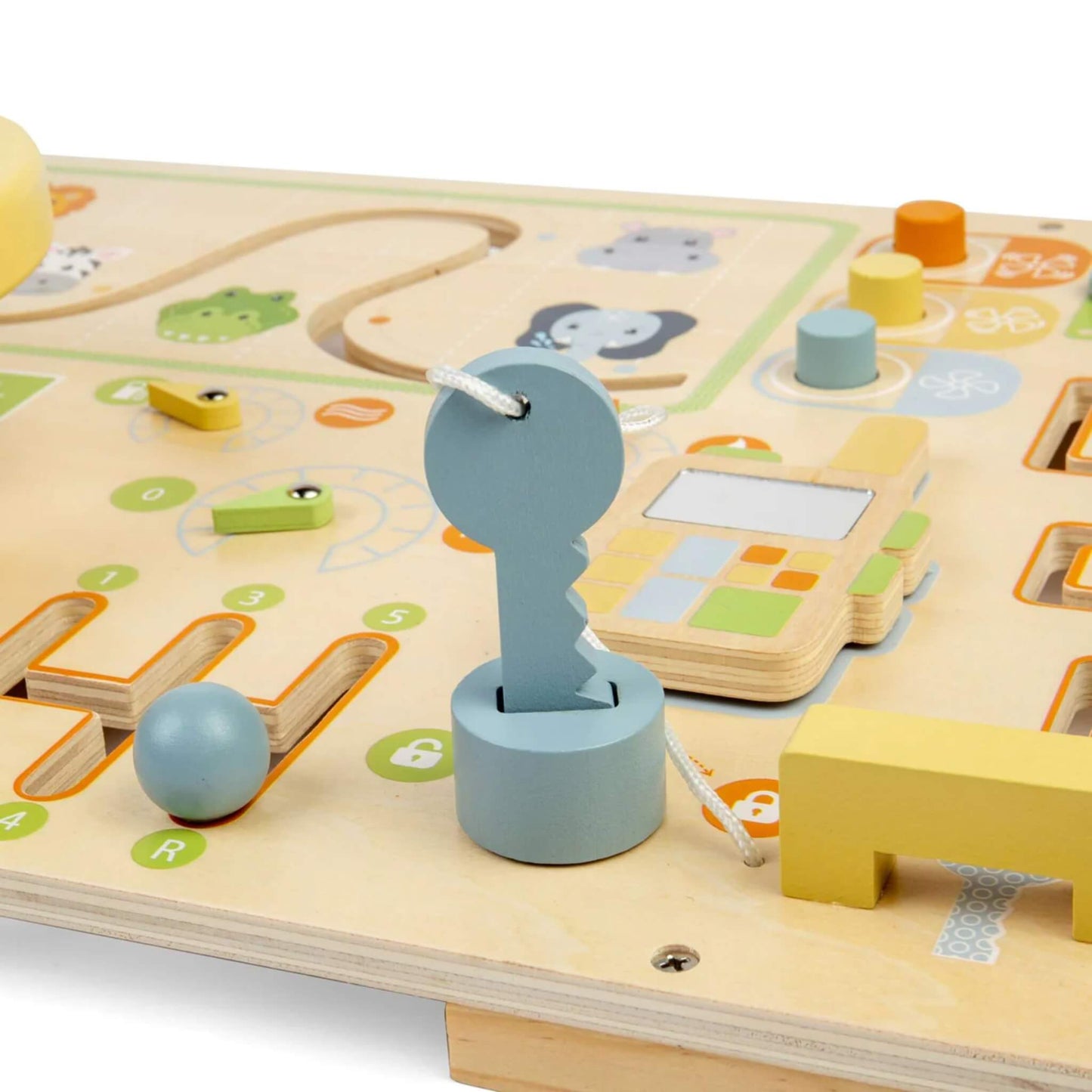Close-up of a wooden key attached with white cord beside a pretend phone and sliding lock mechanism on a sensory busy board.