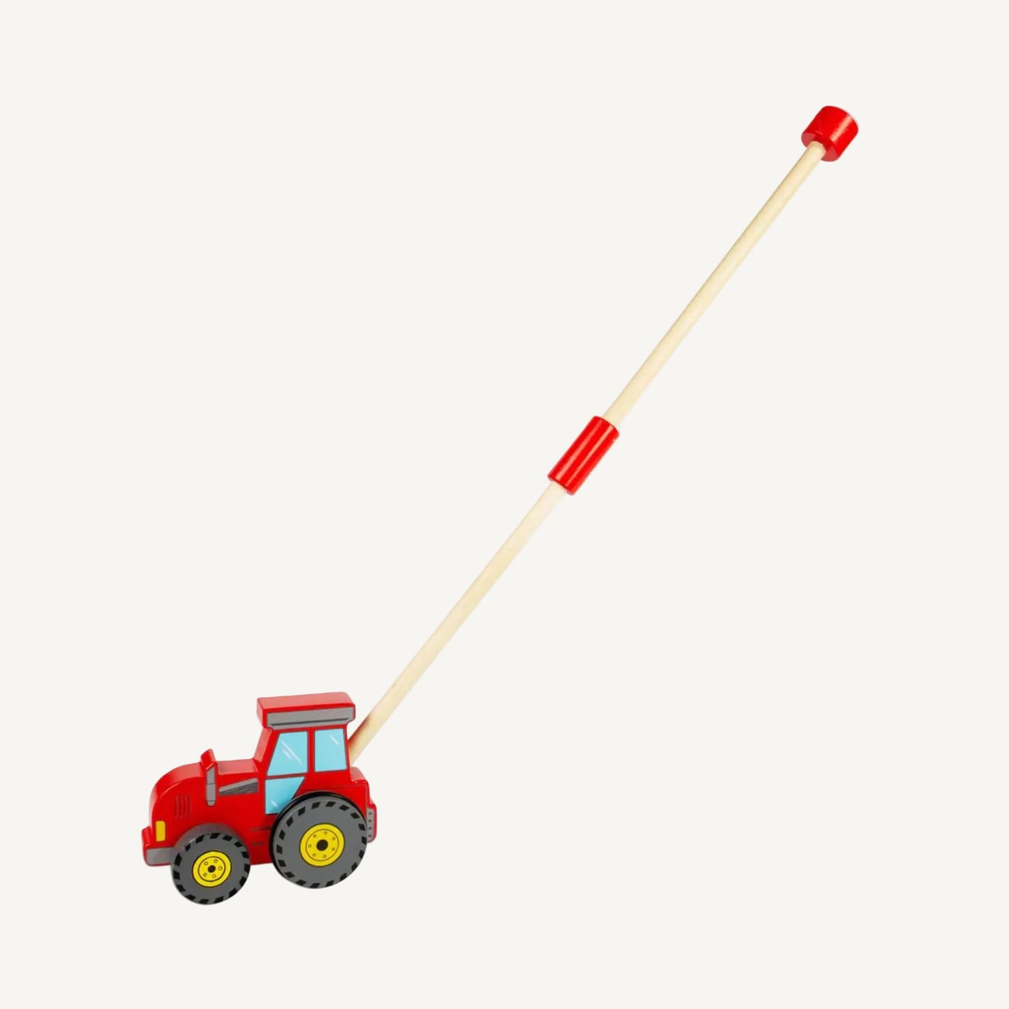 Red wooden tractor push along toy shown with a folded handle position, featuring chunky grey wheels, blue painted windows and a compact wooden design.