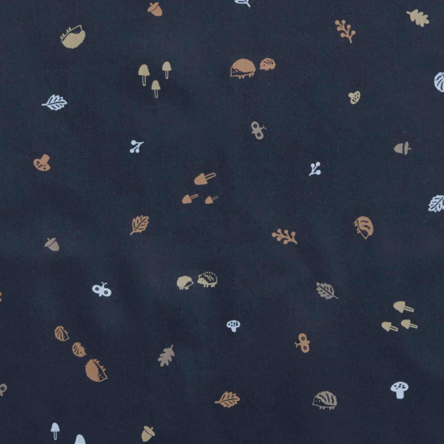Close-up of navy fabric swatch patterned with small woodland motifs including hedgehogs, mushrooms, leaves, and acorns in earthy tones.