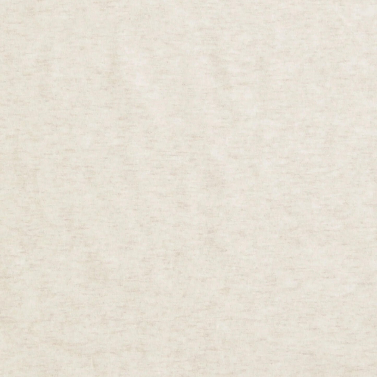 Close-up of plain oatmeal-coloured fabric showing a soft, heathered texture.