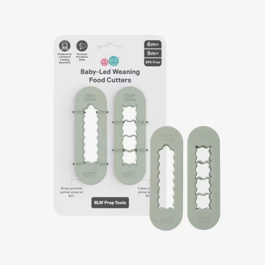 Sage green baby-led weaning food cutters displayed in retail packaging showing strip cutter and cube cutter designed for preparing baby finger foods.