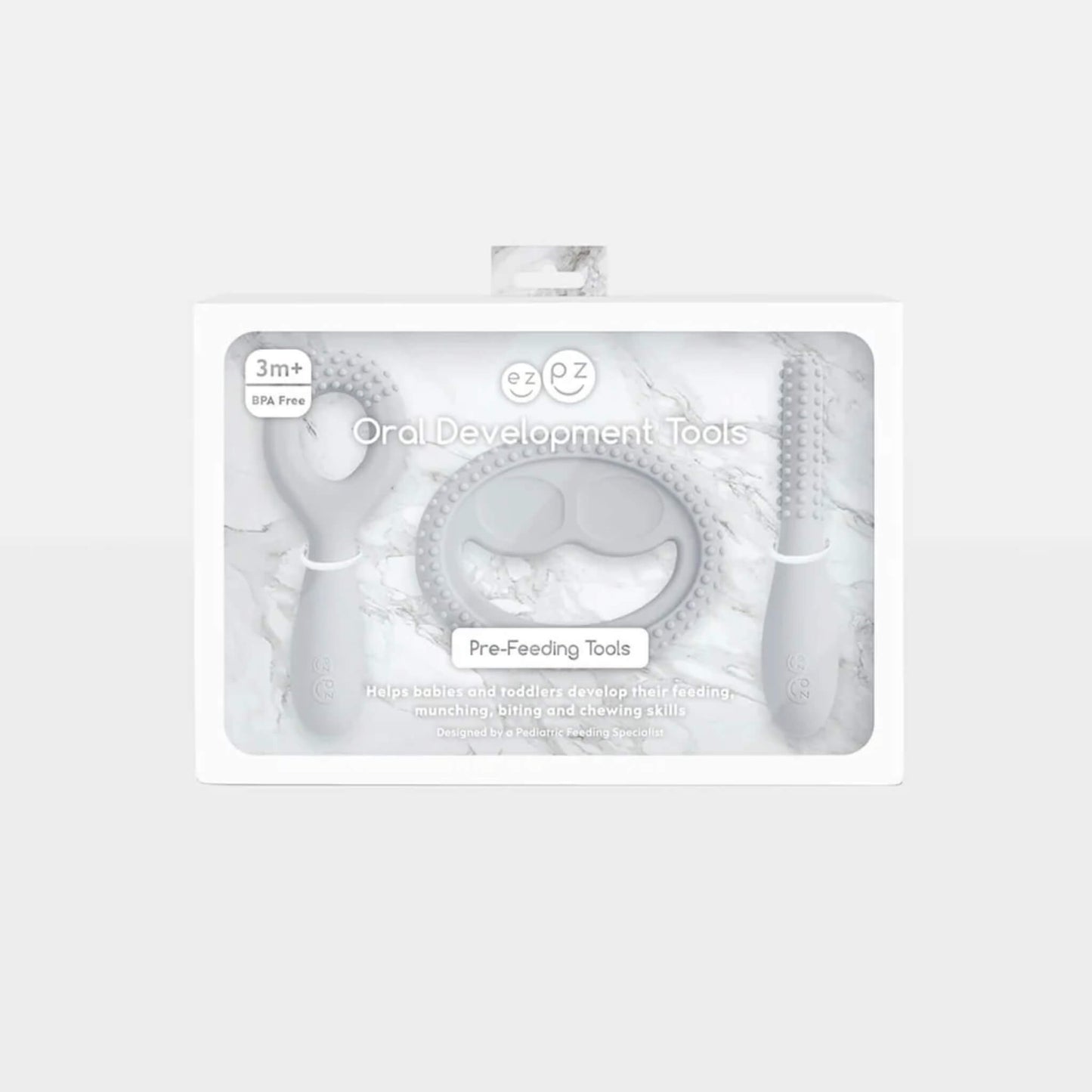 Grey silicone oral development tools displayed in retail packaging labelled oral development tools for babies 3+ months designed to support early feeding skills.