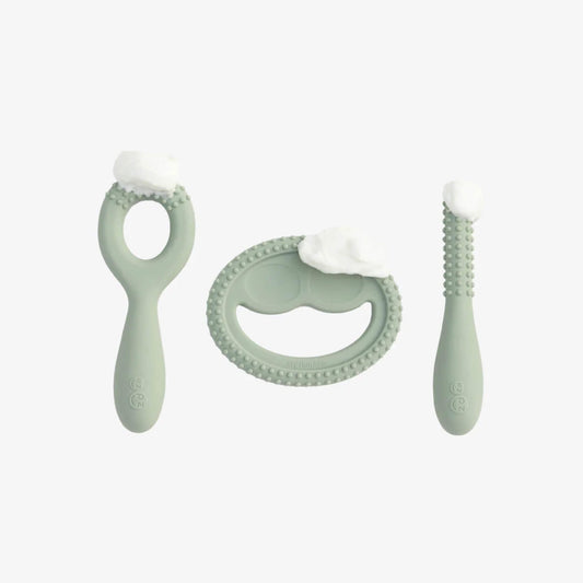 Sage green silicone oral development tools with small dollops of puree placed on textured surfaces to demonstrate how babies explore flavours and practise oral movement.