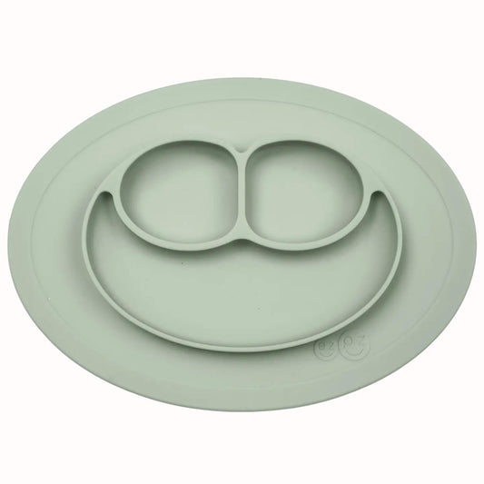 Silicone divided mini mat in sage with separate food sections designed for toddler meals and snacks.