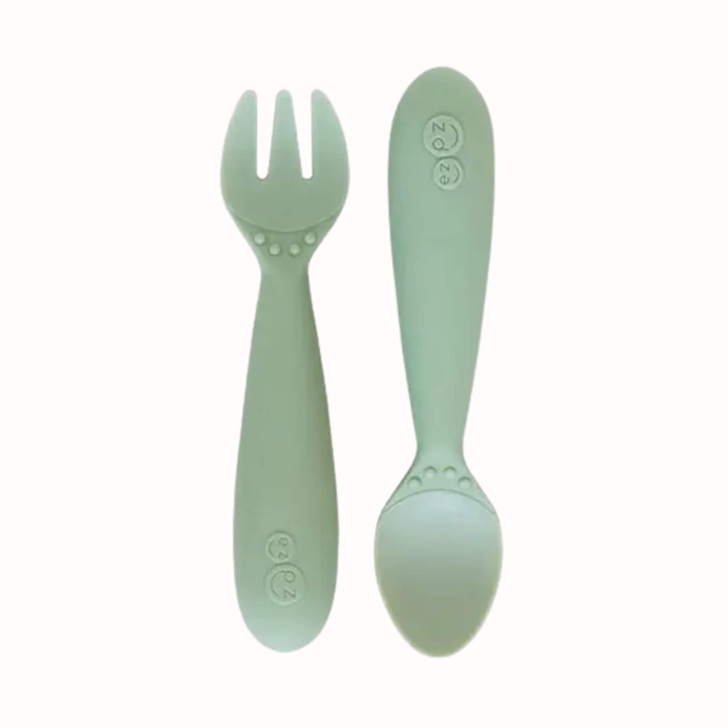 Sage silicone toddler fork and spoon with chunky handles sized for smaller hands.