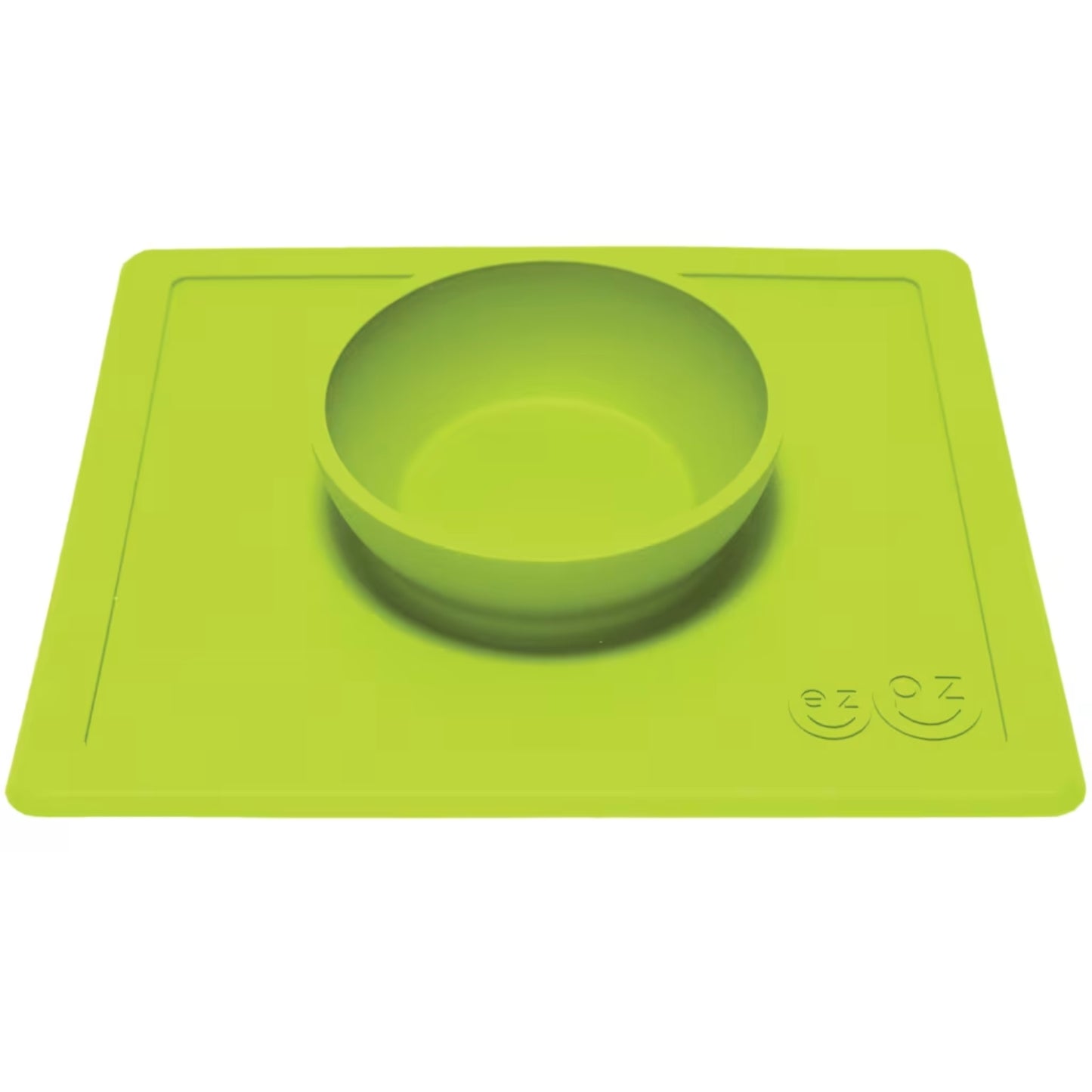 Lime silicone bowl attached to a flat rectangular placemat, shown from an angle to highlight the depth of the bowl.