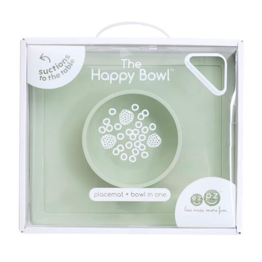 Retail packaging box showing the Happy Bowl in sage. The front displays a product illustration, the name “The Happy Bowl” and the description placemat + bowl in one.