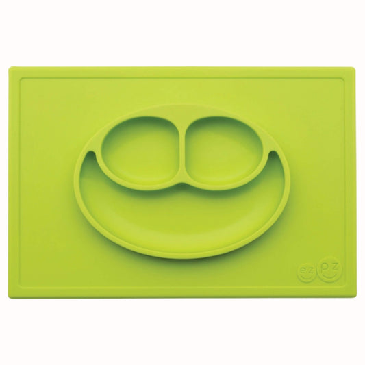 Lime green divided suction plate with two small sections and one larger section placed on a matching silicone placemat.