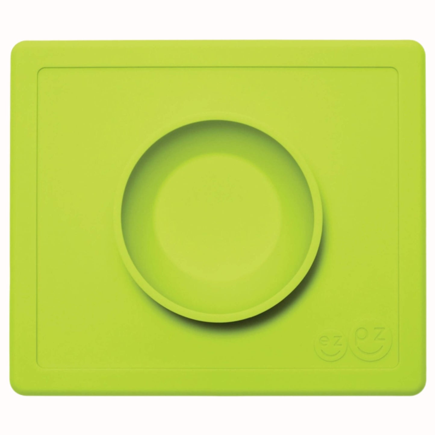 Lime green suction bowl placed in the centre of a matching rectangular silicone placemat.