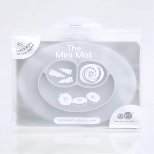 Retail packaging for the Mini Mat silicone suction placemat and plate in pewter grey with illustrated food compartments on the front.