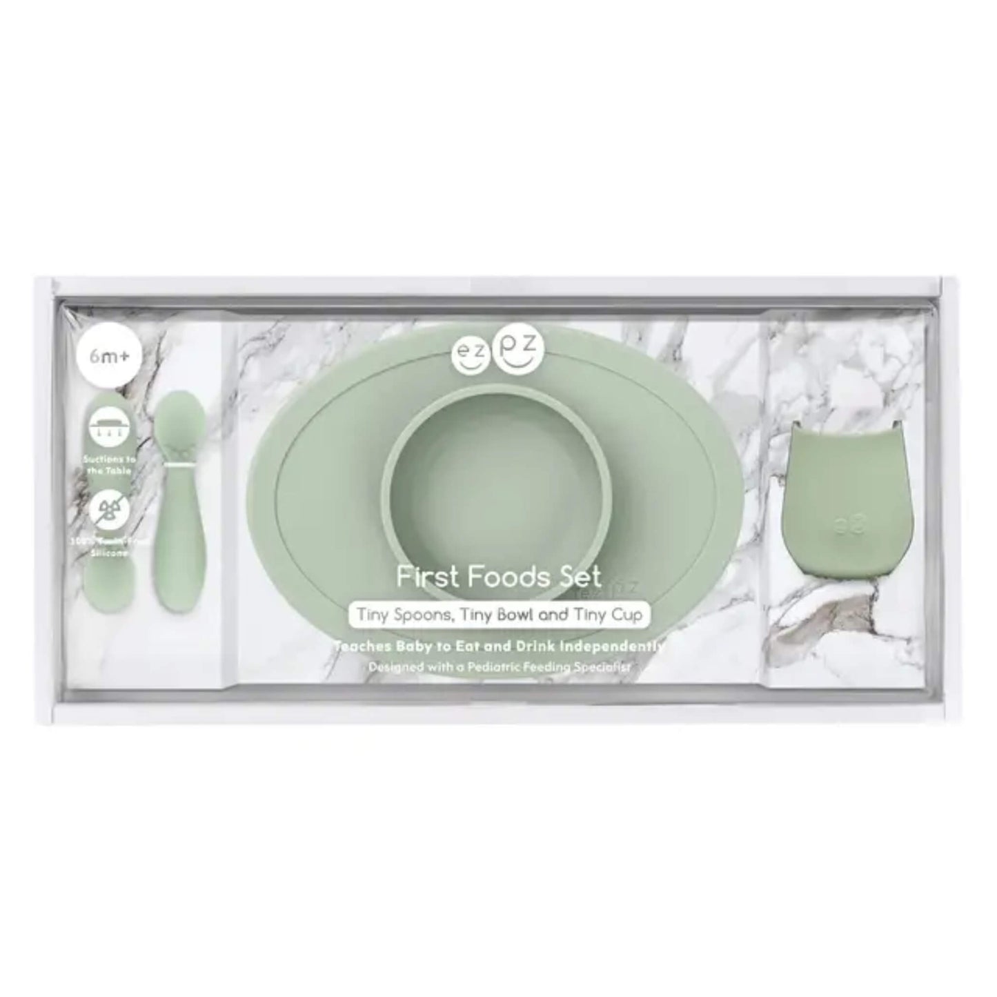 First foods baby weaning set in sage green featuring a suction bowl, open cup and two soft silicone spoons for babies learning to self-feed.