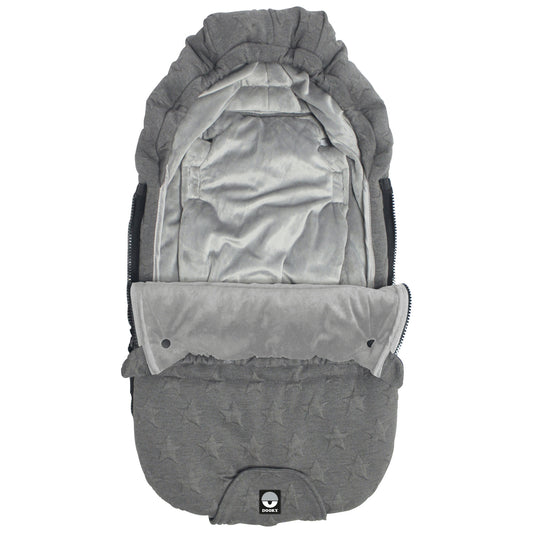 A softly padded footmuff with a quilted star pattern, shown with the front section partially unzipped to reveal a plush velour-style inner lining.