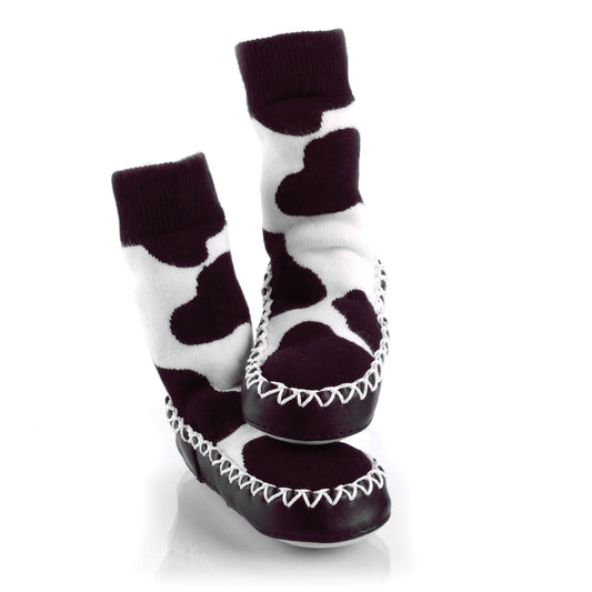 Cow print design Mocc Ons Moccasin sock style slippers with a soft sole. For keeping toes warm.