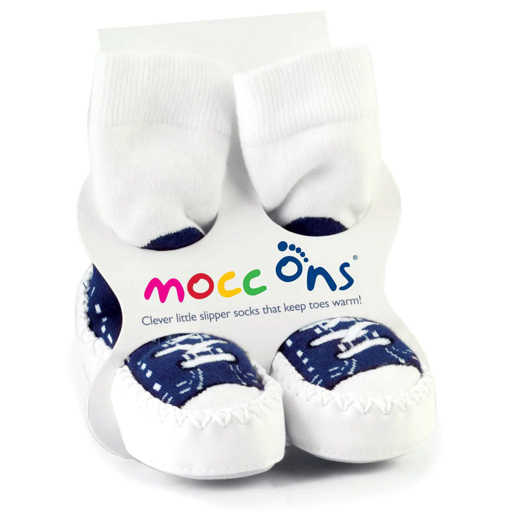 Mocc Ons Navy Sneaker slipper socks in packaging, featuring white cotton socks stitched to soft white soles with navy blue sneaker-style detailing.