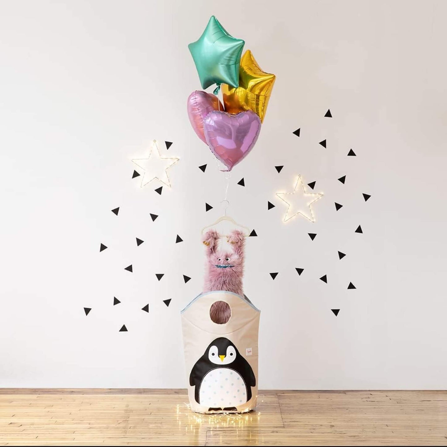 Decorative display of the 3 Sprouts Penguin Hamper in a playroom, styled with balloons and lights to show fun and gift appeal.