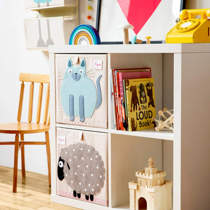 3 Sprouts Cat Storage Box shown in a white shelving unit beside children's books and toys, with a matching Sheep box below.