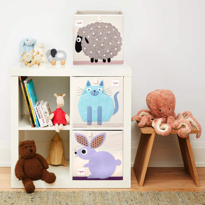 Blue Cat Storage Box styled in a cube shelf with matching Rabbit and Sheep boxes, surrounded by books, plush toys, and playroom decor.