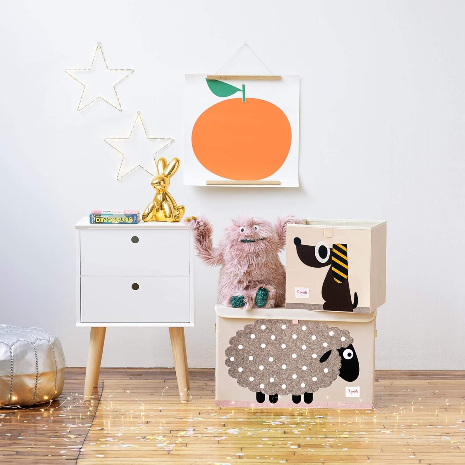 3 Sprouts Dog Storage Box placed on top of a matching sheep toy chest, styled with plush toys, a gold rabbit, and playful wall art in a child's bedroom.